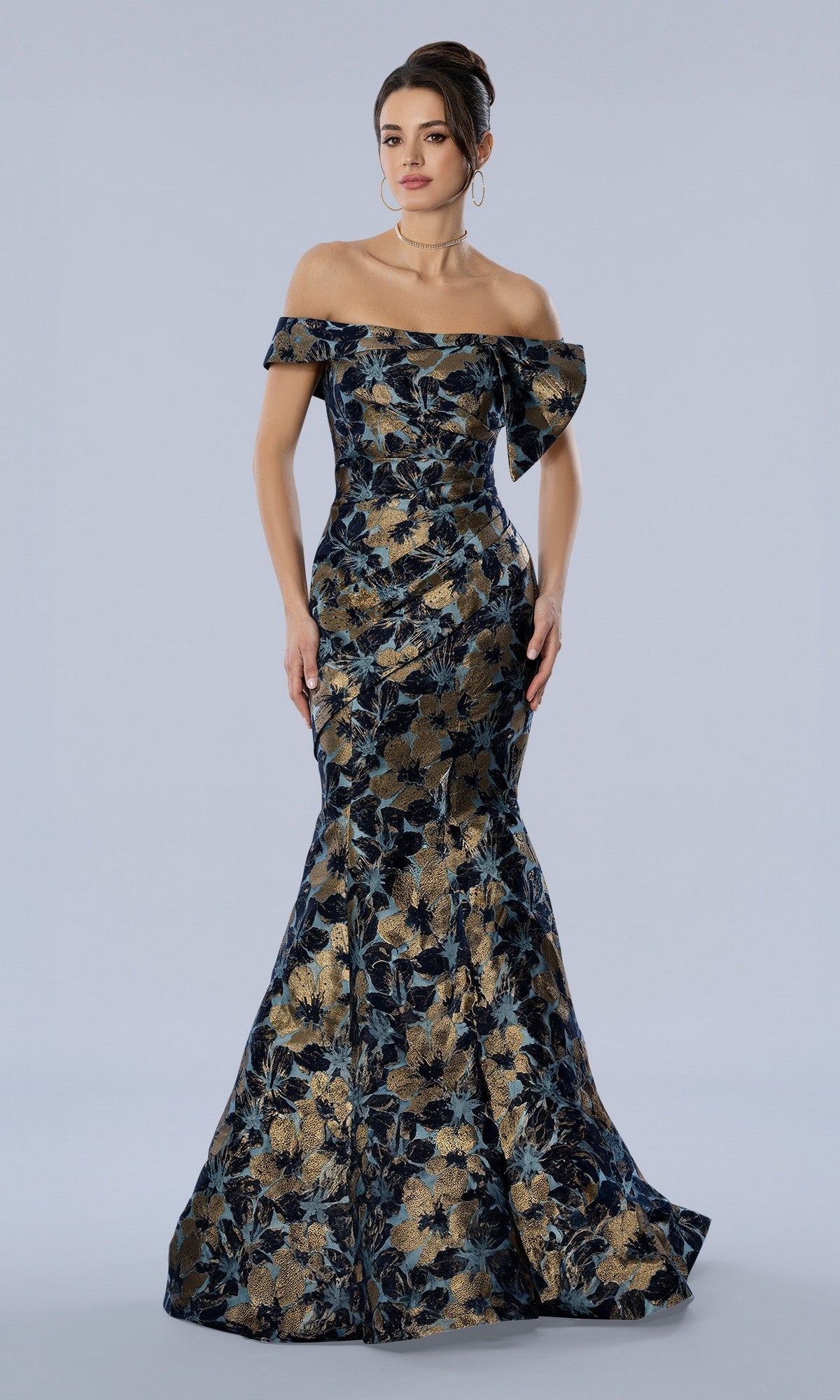A woman wearing the Stella Couture 26354 long formal dress in navy stands against a plain light background.